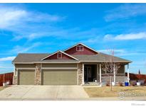 Charming single-Gathering home featuring a two-car garage and covered front porch perfect for relaxing at 781 Rodgers Cir, Platteville, CO 80651