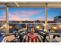 Enjoy beautiful sunsets from this spacious balcony with comfortable seating and city views at 888 N Logan St # 11E, Denver, CO 80203