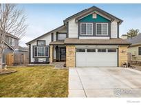 Charming two-story home with attached two car garage and inviting front lawn at 9094 W 103Rd Ave, Broomfield, CO 80021