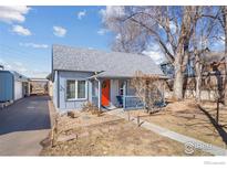 Charming single-story home with blue siding, a vibrant orange front door, and a cozy front porch at 103 Sunset St # A, Longmont, CO 80501