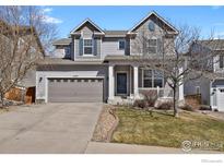 Charming two-story home with a well-maintained lawn and a two-car garage at 1429 Wandering Way, Castle Rock, CO 80109