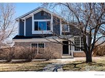 Charming two-story home with brick and siding, complemented by a well-manicured lawn and mature trees at 2285 Autumn Ridge Blvd, Lafayette, CO 80026