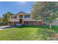 Charming two-story home features a well-maintained front yard and a two-car garage, set under a clear blue sky at 2823 Mountain View Ave, Longmont, CO 80503