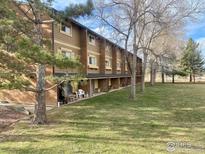 Multi-Gathering home with brick and wood exterior, grassy front yard, and patios at 3161 Madison Ave # 310, Boulder, CO 80303