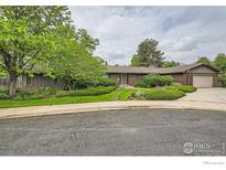 Charming single-story home featuring a brick facade and a beautifully landscaped front yard at 325 Fox Ct, Boulder, CO 80303