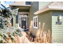 Charming home featuring a front entrance with a black door, sidelights, and address number at 379 W Arapahoe Ln, Boulder, CO 80302