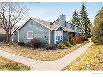 Charming two-story home featuring a blue exterior, well-maintained lawn, and inviting walkway at 3823 Paseo Del Prado, Boulder, CO 80301