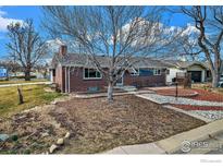 Charming brick single-story home with mature landscaping and inviting curb appeal at 4105 Yarrow Ct, Wheat Ridge, CO 80033