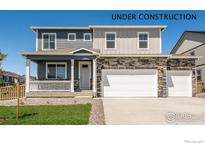 Charming two-story home with a porch, a three-car garage and stone detailing, offering curb appeal at 4113 Marble Dr, Mead, CO 80504