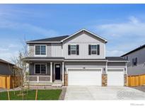 Charming two-story home featuring a three-car garage and inviting front porch at 4113 Marble Dr, Mead, CO 80504