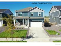 Two story home with blue siding, stone accents, a two car garage and a well manicured lawn at 4113 Marble Dr, Mead, CO 80504