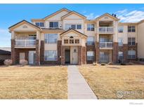 Inviting condo complex with balconies, brick accents and well-maintained landscaping at 5735 N Genoa Way # 11-205, Aurora, CO 80019