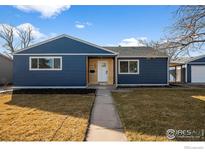 Charming blue home with a well-manicured lawn and inviting facade at 895 Oswego St, Aurora, CO 80010