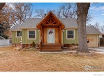 Charming single-story home featuring a wood-shingled gable and a well-manicured front lawn at 1113 Collyer St, Longmont, CO 80501