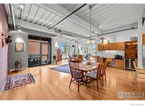 Bright open-concept living room with modern industrial-style ceilings and lots of natural light at 1360 Walnut St # 304, Boulder, CO 80302