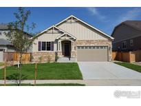 Charming single-Gathering home with stone accents, a well-manicured lawn and attached two car garage at 17012 Lipan St, Broomfield, CO 80023