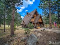 A-frame home with rustic charm, surrounded by mature trees and a tranquil setting at 208 Wild Tiger Rd, Boulder, CO 80302