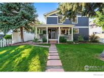 Charming two-story home featuring a welcoming front porch, a stone walkway, and mature trees at 2625 6Th St, Boulder, CO 80304