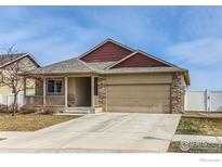 Charming single Gathering home showcasing stone accents, neutral paint, covered porch, and a two car garage at 3318 Auklet Dr, Berthoud, CO 80513