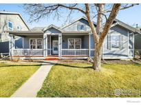 Charming home featuring a covered porch, well-maintained lawn, and inviting curb appeal at 4004 Ravenna Pl, Longmont, CO 80503