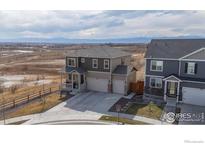 Inviting two-story home with a well-manicured lawn and an attached two-car garage at 4401 Garnet Way, Mead, CO 80504