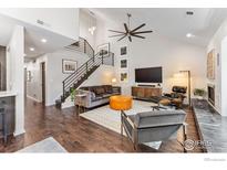 Stylish living room featuring modern decor, a sleek fireplace, and a unique staircase design at 4475 Laguna Pl # 309, Boulder, CO 80303