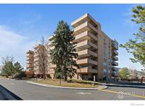 View of brick building with several balconies and trees in front at 500 Mohawk Dr # 510, Boulder, CO 80303