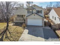 Charming two-story home features a front porch and attached two-car garage at 5366 Badger Ln, Frederick, CO 80504