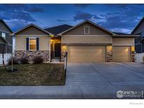 Charming single-story home with a three-car garage and stone accents at 5396 Neighbors Pkwy, Firestone, CO 80504