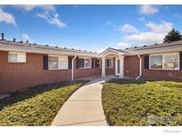 Charming brick home with a well-manicured front yard and a welcoming entrance at 5425 County Road 32 # 27, Mead, CO 80504