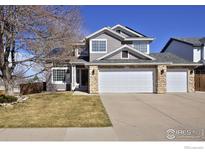 Charming two-story home with a three car garage and well-maintained lawn in a suburban neighborhood at 9436 Cody Dr, Broomfield, CO 80021