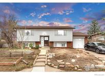 Charming two-story home with an attached garage, landscaped front yard, and inviting curb appeal at 4120 Aurora Ave, Boulder, CO 80303