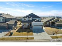 Beautifully landscaped home with a well-maintained lawn and a large driveway for ample parking at 655 Lene Ln, Berthoud, CO 80513