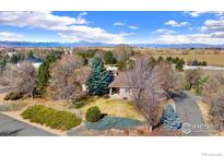 Charming single-story home surrounded by mature trees and landscaping with mountain views at 109 Blue Heron Ct, Mead, CO 80542