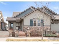 Charming exterior with stone accents, well-maintained landscaping, and inviting entryway at 1160 Summit View Dr, Louisville, CO 80027