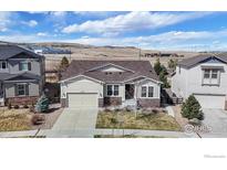 Charming single-story home with a two-car garage, stone accents, and a well-manicured lawn in a suburban neighborhood at 11829 Deorio St, Parker, CO 80134