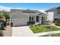 Inviting home with a well-manicured lawn and a two-car garage, showcasing curb appeal at 11829 Deorio St, Parker, CO 80134