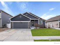 Charming home featuring a gray exterior, attached garage, and well-maintained front yard at 1525 Waterman St, Berthoud, CO 80513