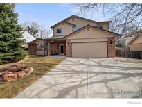 Inviting two-story home with a two-car garage and a well-maintained front yard at 2418 Maplewood E Cir, Longmont, CO 80503