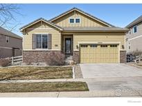 Charming single-Gathering home with a two-car garage, manicured lawn and stone accents on the facade at 3325 Yale Dr, Broomfield, CO 80023