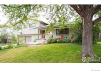Charming home with a well-manicured lawn and inviting front porch seating area at 4705 Chatham St, Boulder, CO 80301