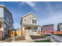 Charming two-story home with a welcoming front porch and professionally landscaped yard at 10291 E 62Nd Pl, Denver, CO 80238