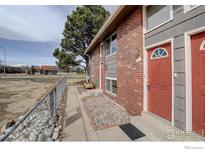 Charming exterior showcasing a well-maintained facade and inviting entrance of the townhouse at 1420 Hover St # 2, Longmont, CO 80501