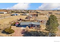Charming single-story home with mature tree, quaint shed, and beautiful exterior paint at 200 Bothun Rd, Berthoud, CO 80513
