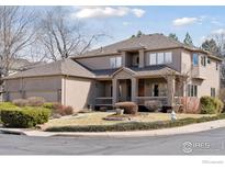 Charming two-story home features a welcoming front porch and a well-maintained yard with mature landscaping at 5338 Pine Valley Ct, Boulder, CO 80301