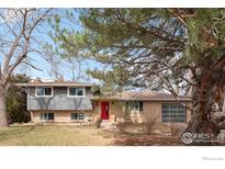 Charming two-story home featuring a brick and siding exterior, well-maintained lawn, and mature trees at 5355 Kewanee Dr, Boulder, CO 80303