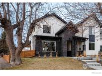 Charming two-story home featuring a stone facade and well-maintained front yard at 1028 Rex St # B102, Louisville, CO 80027