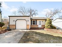 Charming ranch-style home features a single-car garage and well-maintained lawn at 17124 E Wagon Trail Pkwy, Aurora, CO 80015