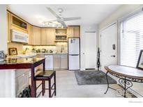 Bright kitchen featuring wood cabinets, sleek appliances, and stylish lighting at 1825 Marine St # 8, Boulder, CO 80302