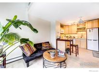 Cozy living room adjacent to kitchen with stylish furniture and bright, natural light at 1825 Marine St # 8, Boulder, CO 80302